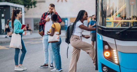 passengers happily boarding a bus